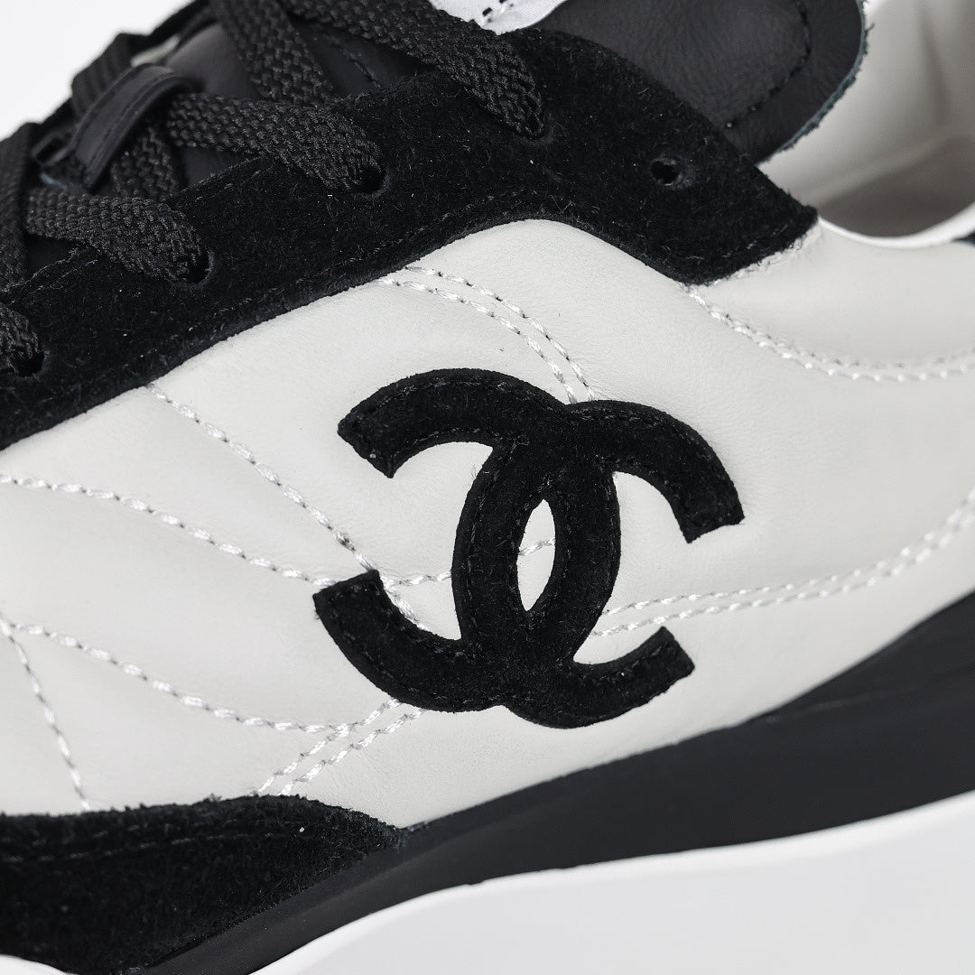 Chanel CC Logo Runner Sneakers – White Quilted Leather & Black Suede